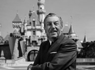 Walt Disney in front of Disneyland Castle